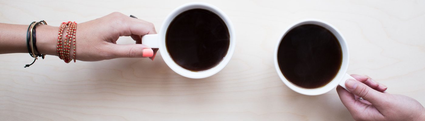 Two Hands with Coffee Cups
